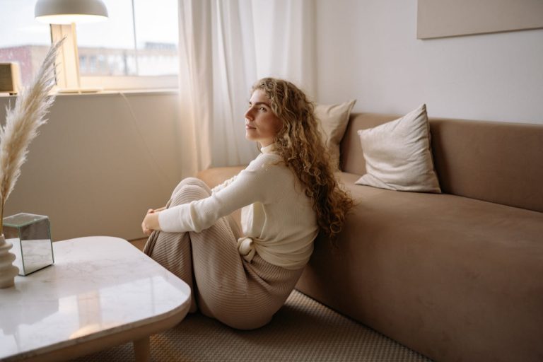 woman-in-white-long-sleeve-shirt-sitting-on-the-floor